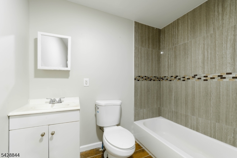 874 South 16th Street Newark, NJ 07108 - Photo 16 of 22 a bathroom with a sink a toilet and shower