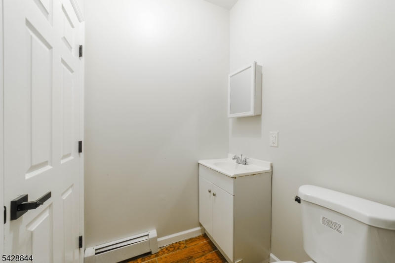 874 South 16th Street Newark, NJ 07108 - Photo 19 of 22 a bathroom with a sink toilet and a mirror