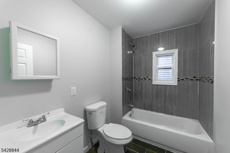 874 South 16th Street Newark, NJ 07108 - Photo 6 of 22 a bathroom with a sink toilet and shower