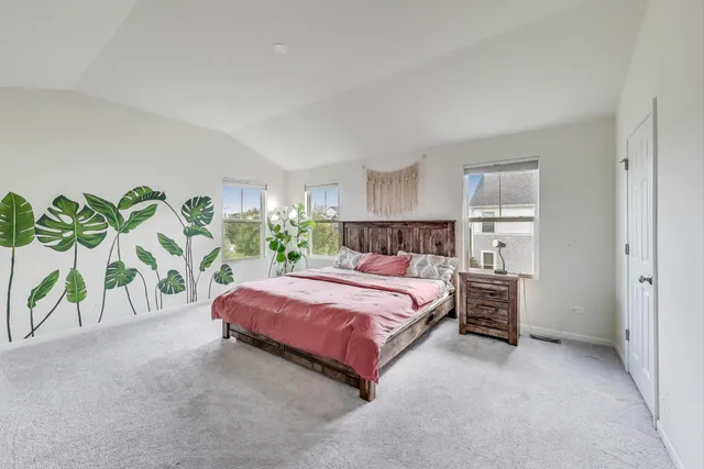 a bedroom with a bed and a plant
