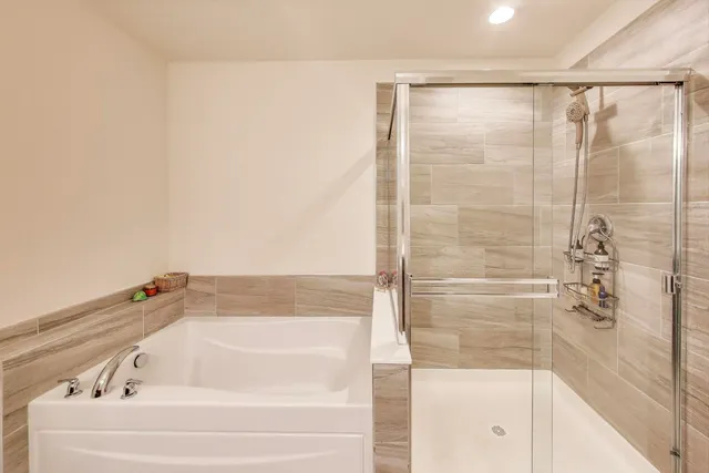 a bathroom with a bathtub and shower