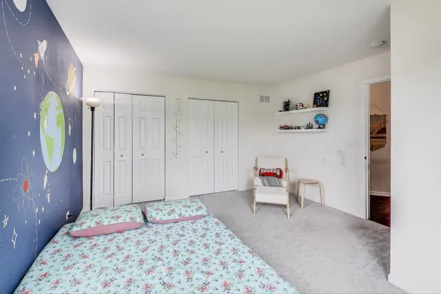 a bedroom with a bed and a couch