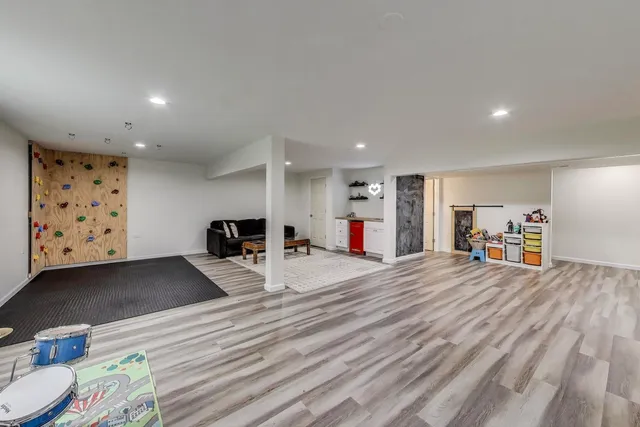 a view of a kitchen with furniture and wooden floor
