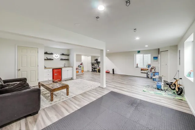 a living room with furniture and a piano