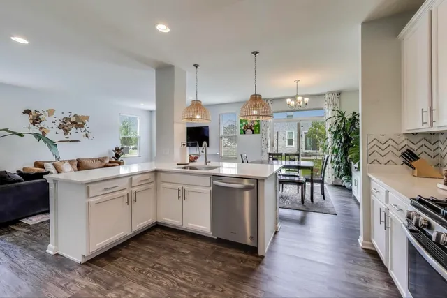 a kitchen with a sink stove and cabinets