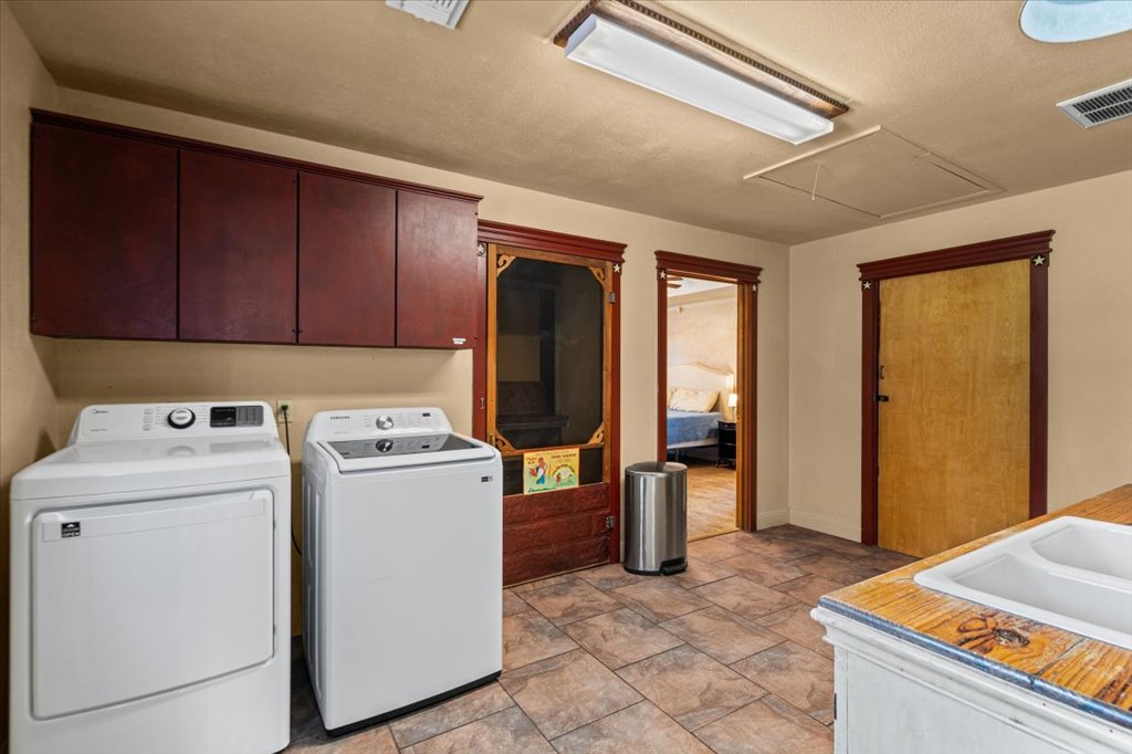 2421 Post Oak Road Webberville, TX 78653 - Photo 12 of 36 Right off the kitchen is the utility and laundry room.