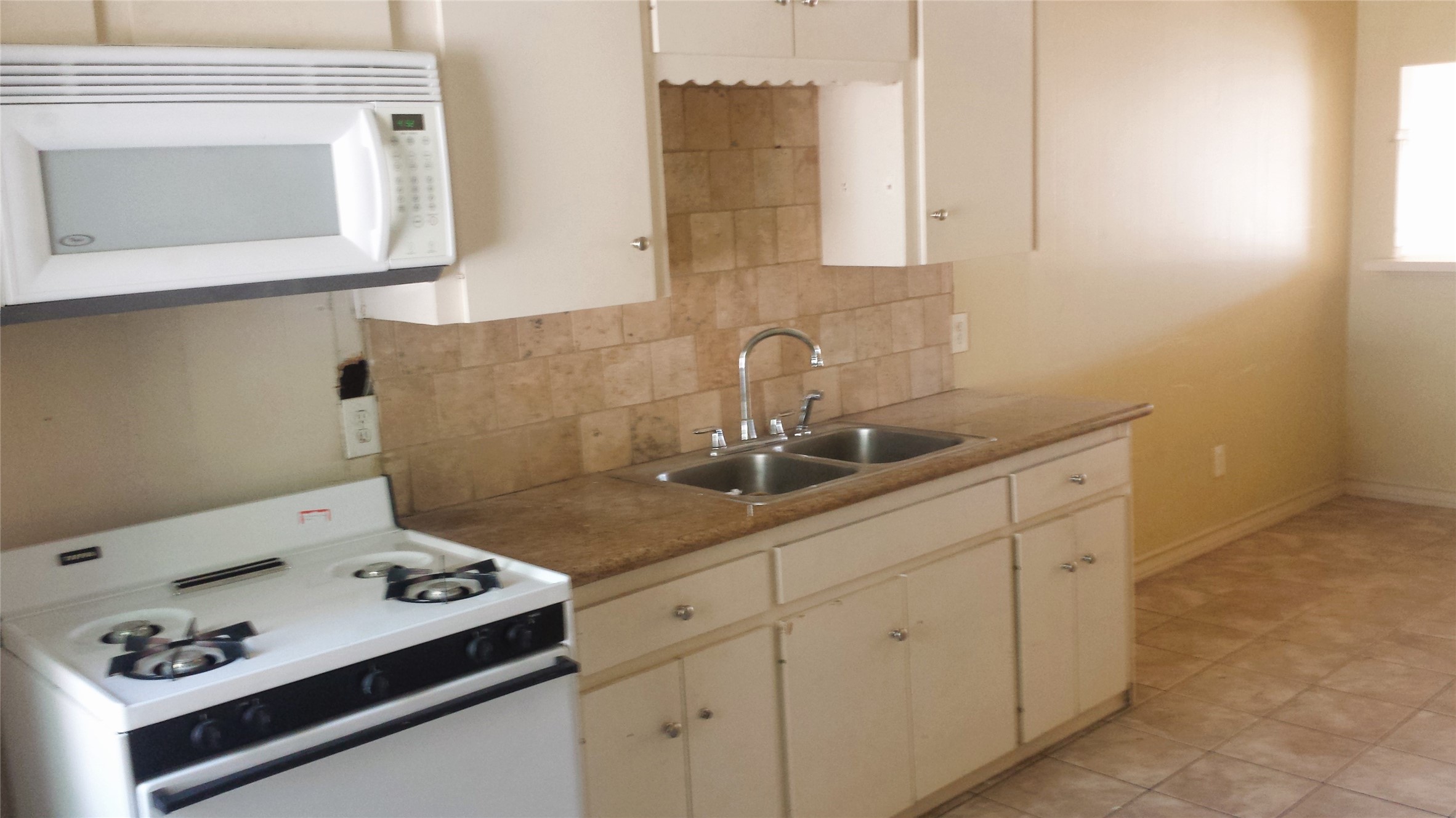 3810 Cochran Street Houston, TX 77009 - Photo 3 of 12 a sink with white cabinets