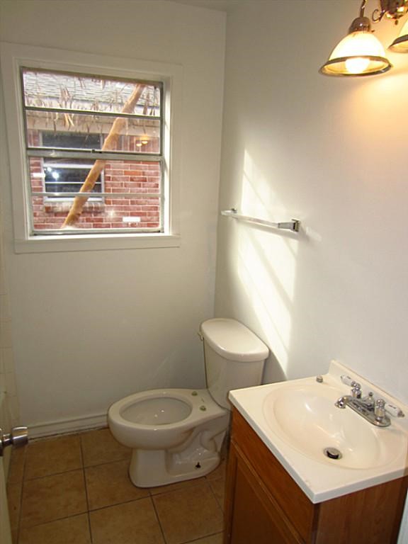 3810 Cochran Street Houston, TX 77009 - Photo 9 of 12 a bathroom with a toilet a sink and a window