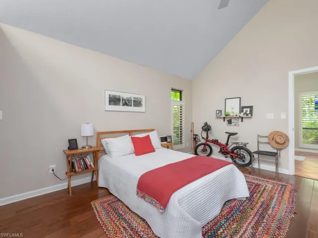a bedroom with bed and wooden floor