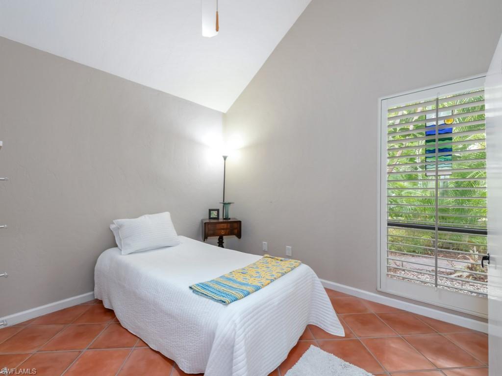 1271 Solana Road, Unit E4 Naples, FL 34103 - Photo 14 of 21 a bedroom with a bed and window