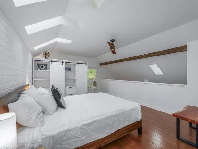 a bedroom with a bed and a chair