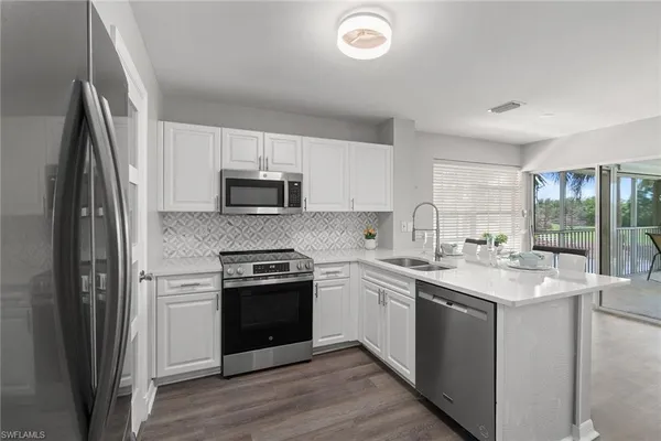 a kitchen with a sink stove and refrigerator