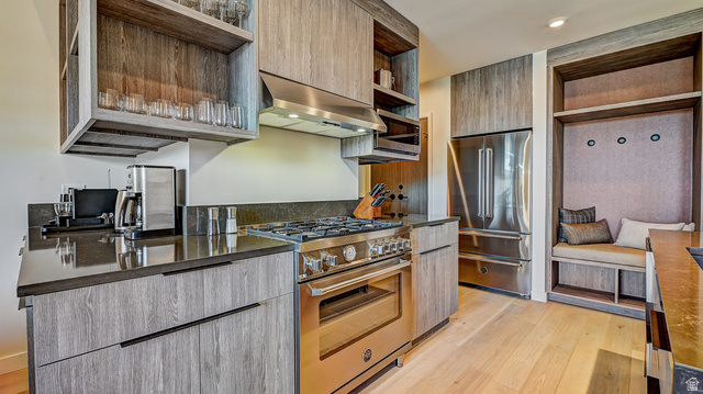 2417 West High Road, Unit 2515 Park City, UT 84098 - Photo 13 of 67 Kitchen featuring open shelves, high quality appliances, modern cabinets, light wood-style floors, and extractor fan