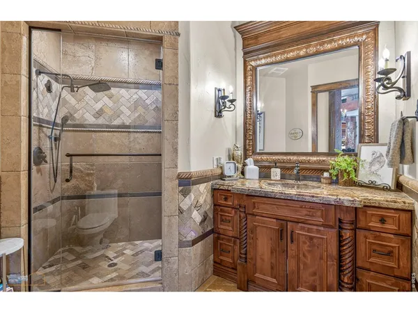 a bathroom with a granite countertop sink mirror and