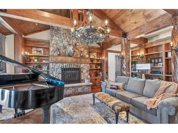 a living room with furniture a couch and chandelier