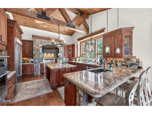 a kitchen with a table chairs and wooden floor