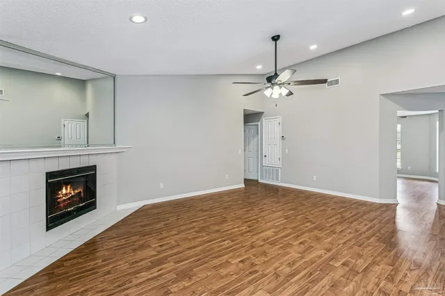 a view of livingroom with fireplace wooden floor and chandelier