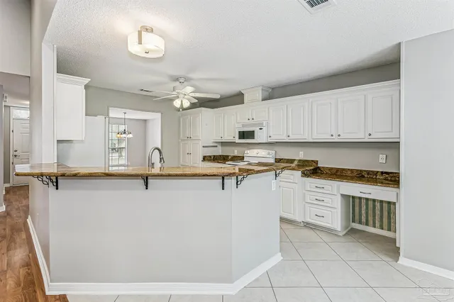 a kitchen with stainless steel appliances a sink stove and cabinets