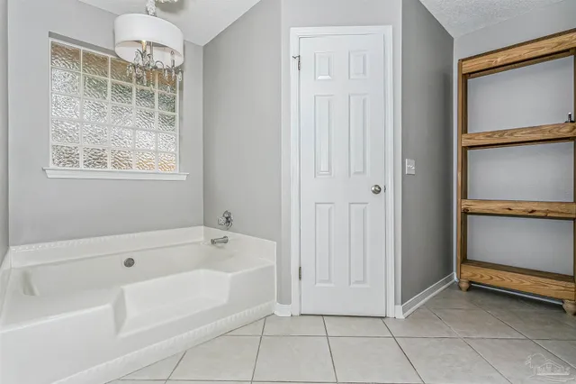 a bathroom with a tub shower and sink