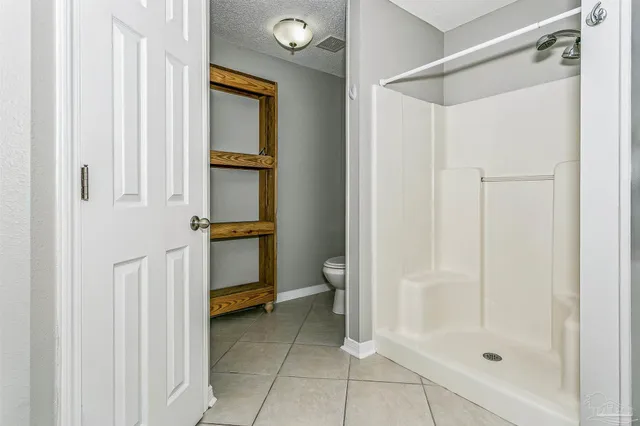 a bathroom with a shower and a toilet