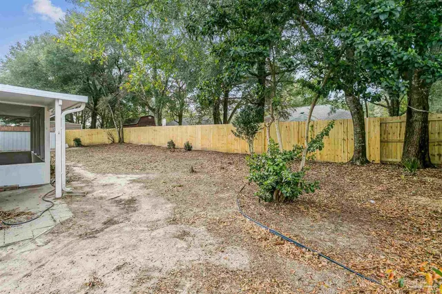 a room with lots of books and a view of living room
