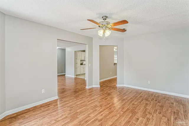 a view of an empty room and wooden floor