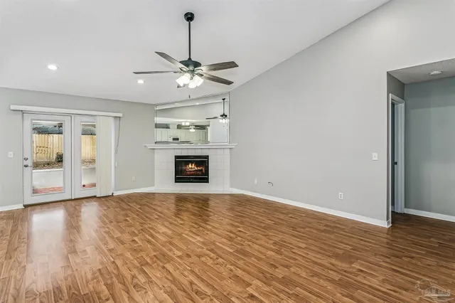 a view of empty room with wooden floor and fireplace