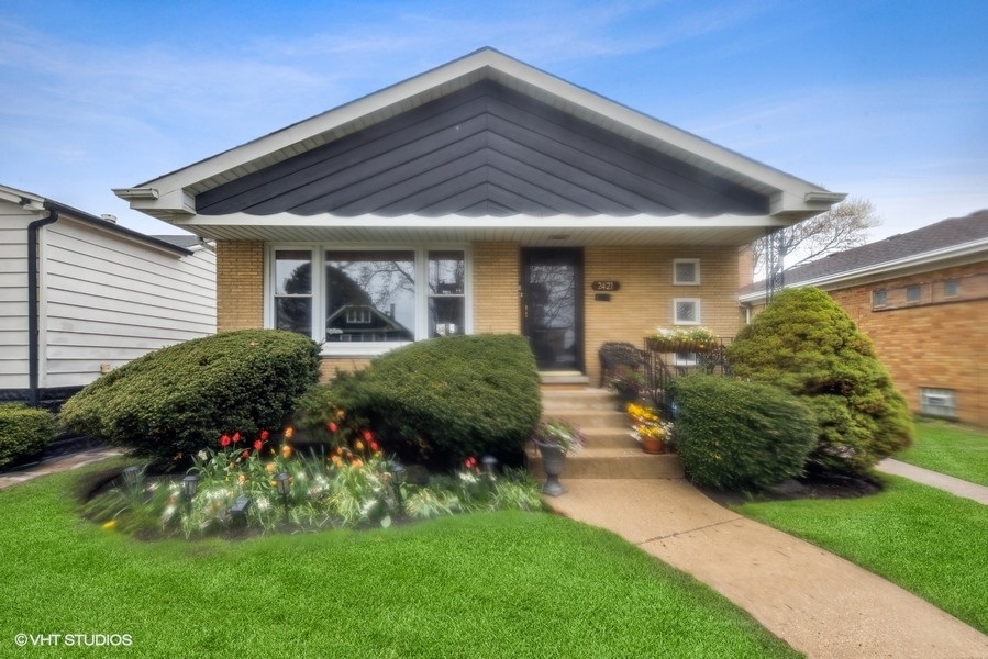 2421 Keystone Avenue North Riverside, IL 60546 - Photo 2 of 24 a front view of a house with a garden