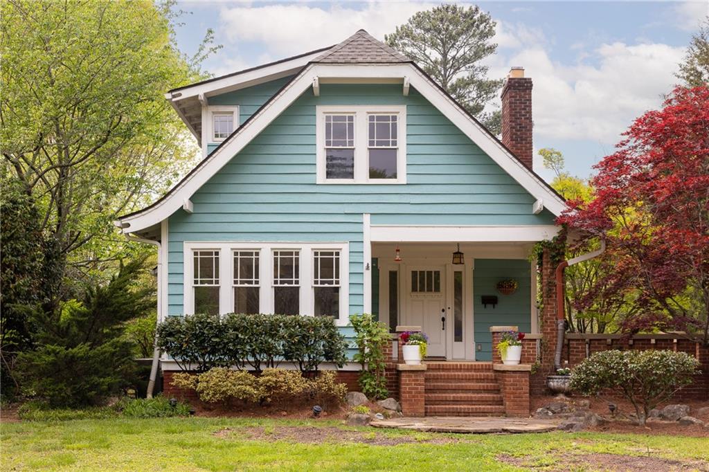 a view of a house with backyard porch and sitting area