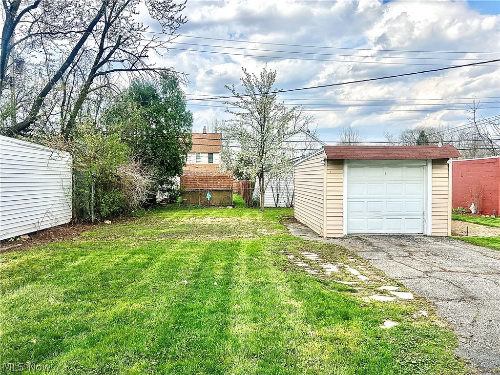67 Forbes Road Bedford, OH 44146 - Photo 20 of 20 View of yard with an outdoor structure, a garage, and driveway