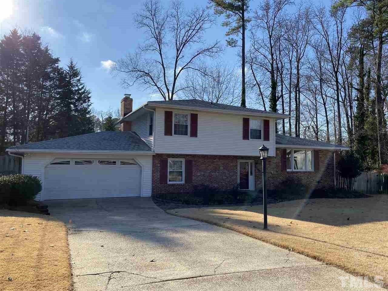 1001 Rutgers Court Raleigh, NC 27609 - Photo 1 of 14 a view of a white house with a large tree