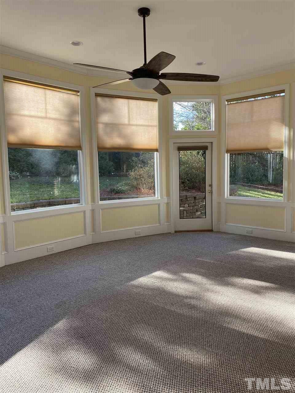 1001 Rutgers Court Raleigh, NC 27609 - Photo 8 of 14 a living room with a large window and a chandelier