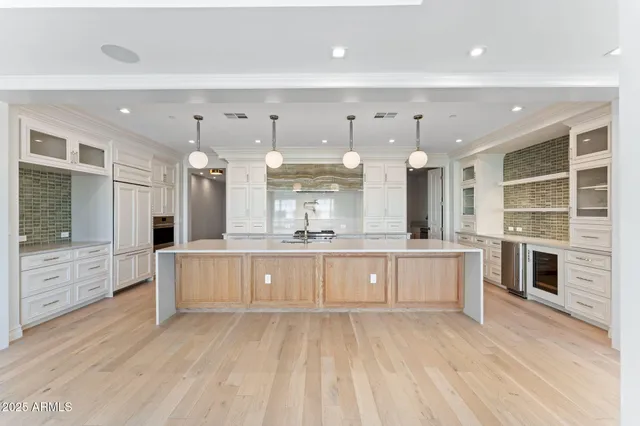 a kitchen with stainless steel appliances granite countertop lots of counter space and windows