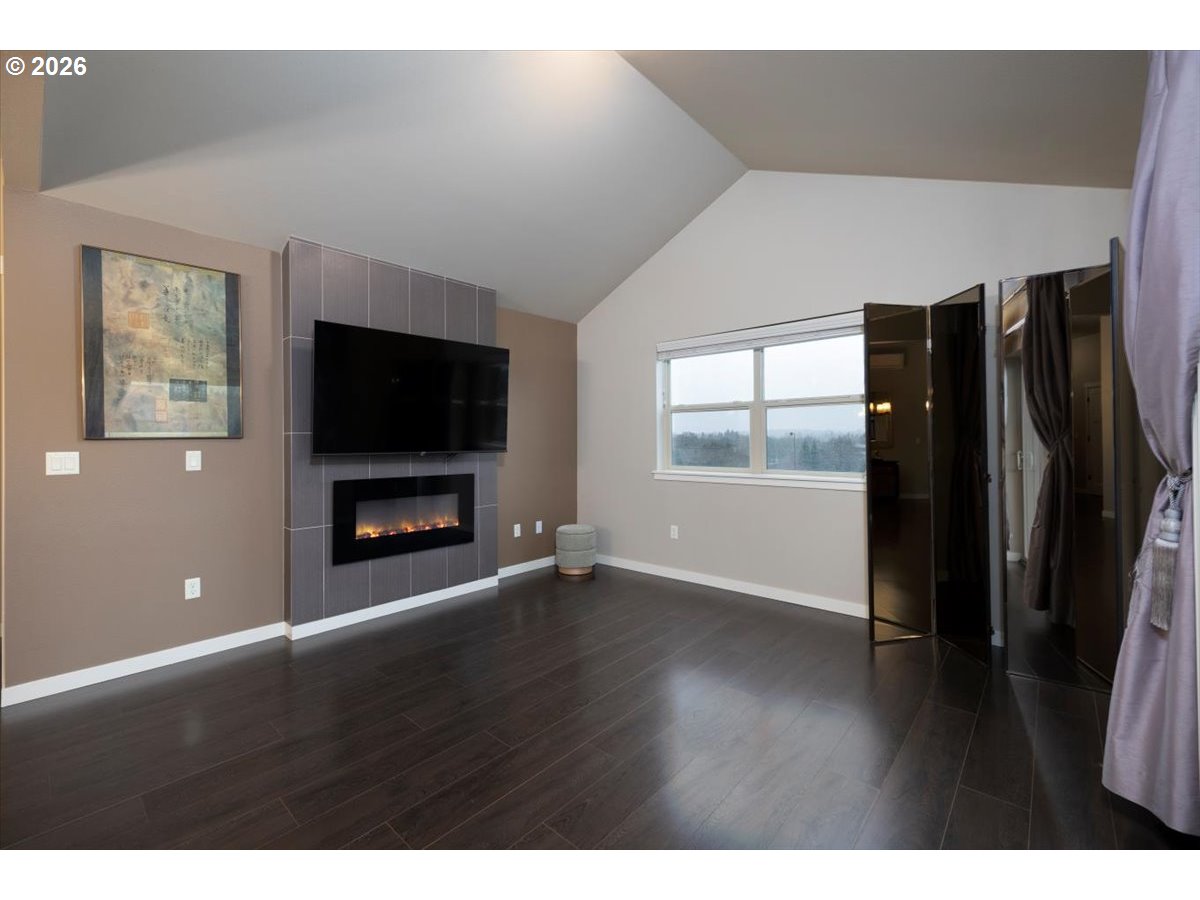 13895 Southwest Meridian Street, Unit 412 Beaverton, OR 97005 - Photo 13 of 38 a view of an empty room with wooden floor and a window