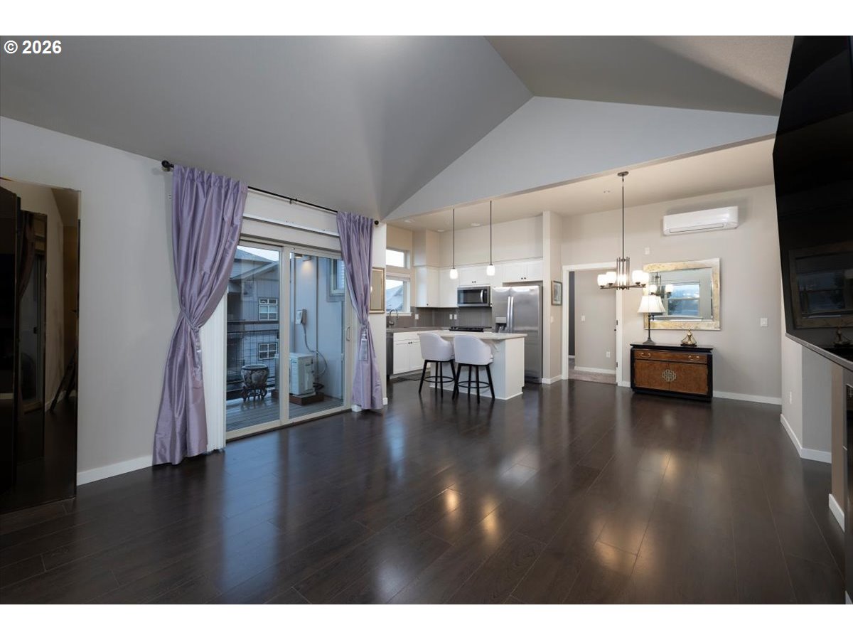 13895 Southwest Meridian Street, Unit 412 Beaverton, OR 97005 - Photo 15 of 38 a view of livingroom with dining room and wooden floor