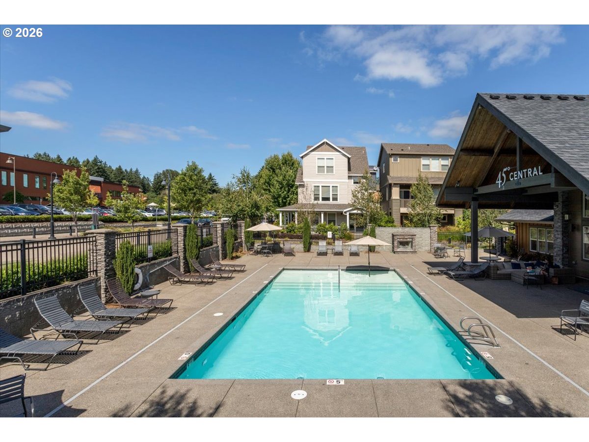 13895 Southwest Meridian Street, Unit 412 Beaverton, OR 97005 - Photo 22 of 38 a view of a swimming pool with a patio and a yard