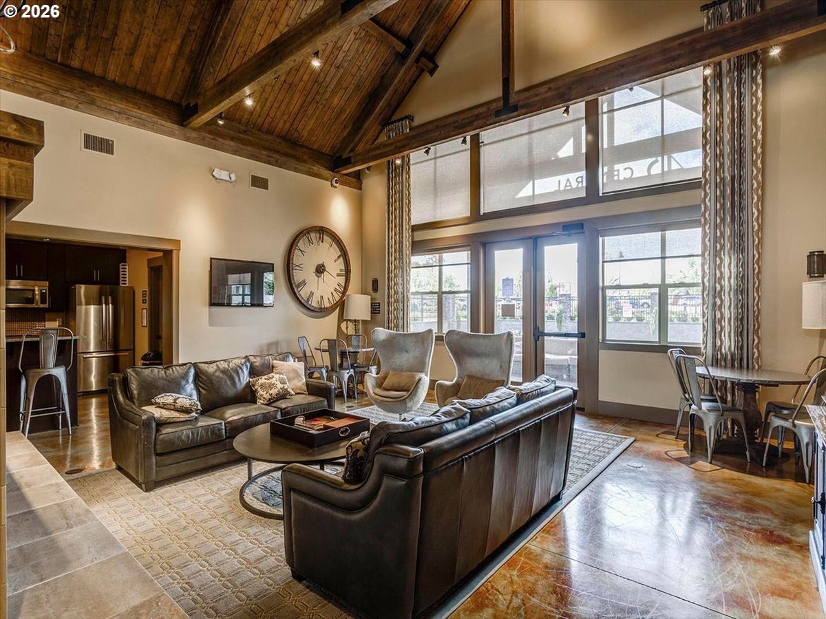 13895 Southwest Meridian Street, Unit 412 Beaverton, OR 97005 - Photo 29 of 38 a living room with furniture a large window and a clock