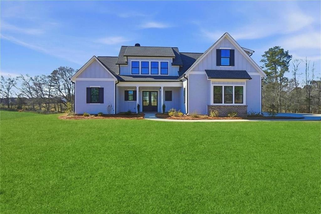 a front view of house with yard and green space