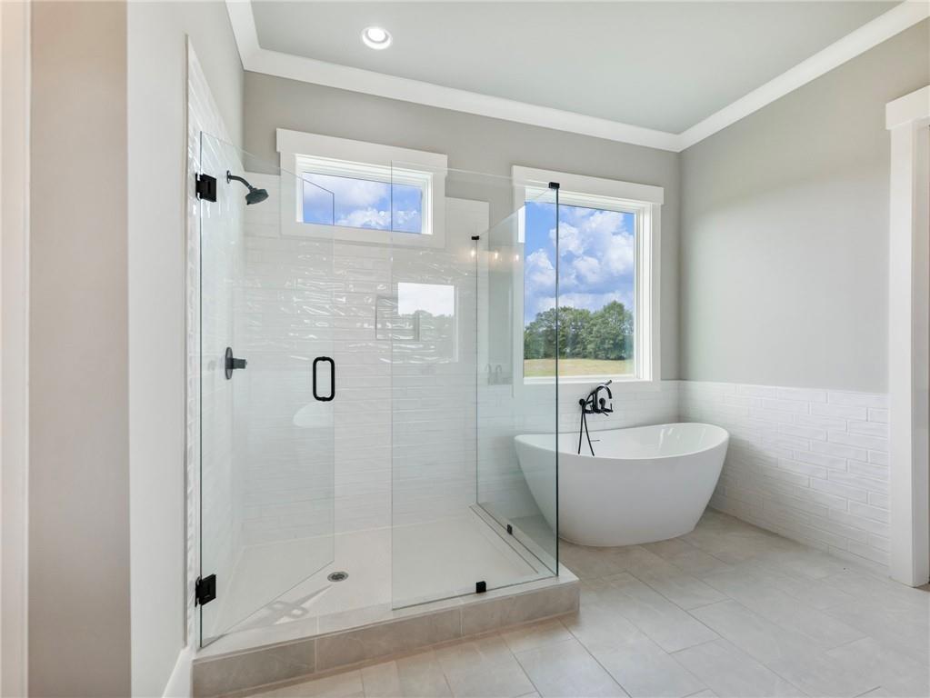 170 Ewing Way Dacula, GA 30019 - Photo 23 of 45 a bathroom with a bathtub and shower
