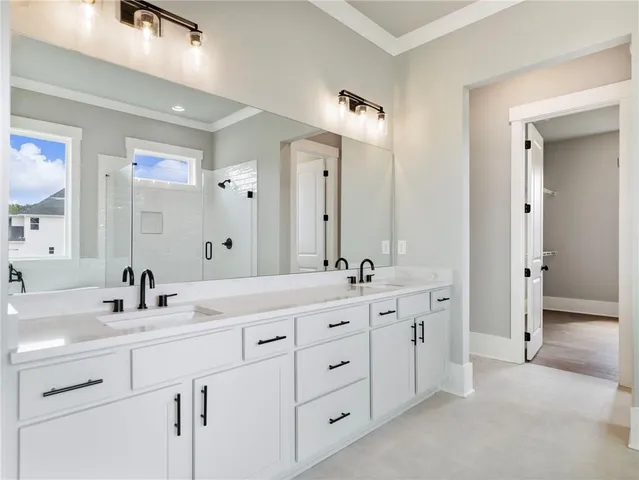 a bathroom with double sink and a mirror