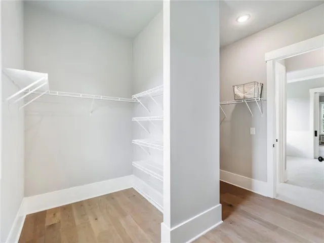 a view of hallway with wooden floor