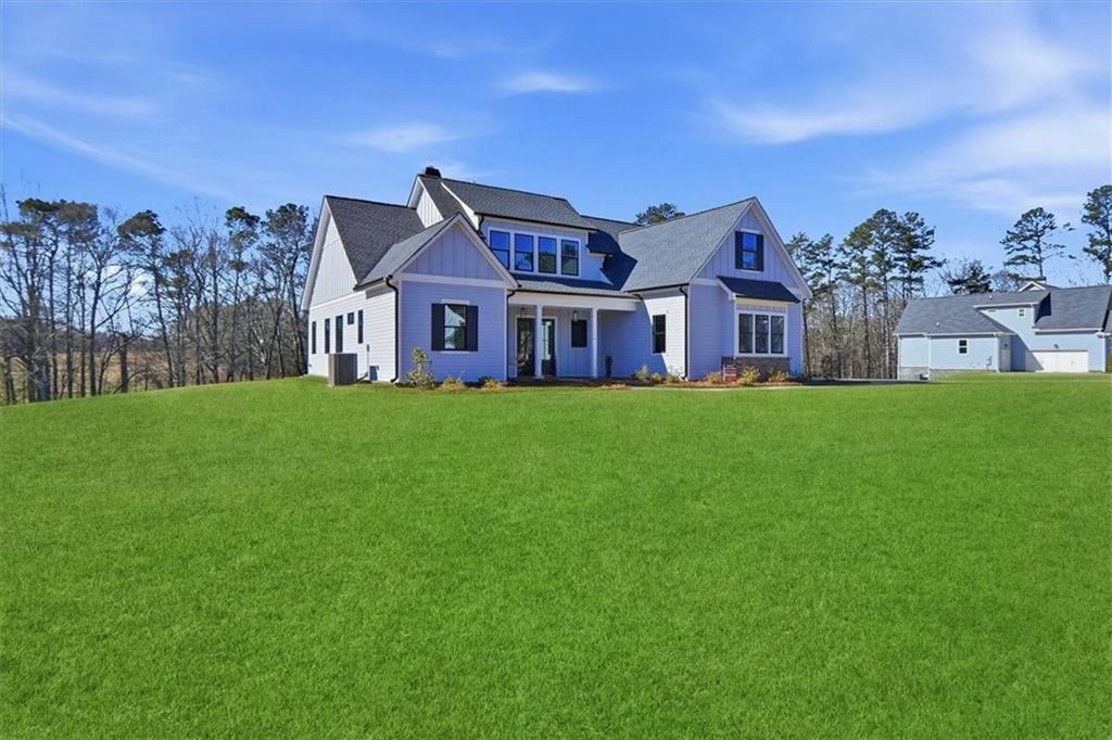 170 Ewing Way Dacula, GA 30019 - Photo 3 of 67 a view of a house with a big yard and large trees