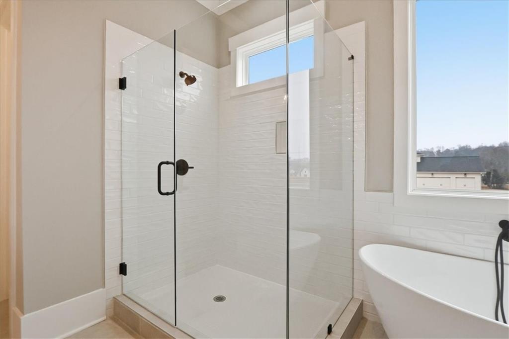 170 Ewing Way Dacula, GA 30019 - Photo 39 of 67 a bathroom with a shower and a bathtub