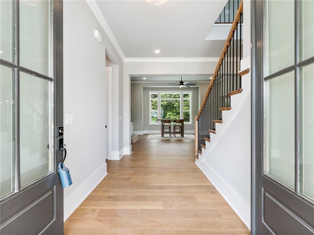 170 Ewing Way Dacula, GA 30019 - Photo 4 of 45 a view of a hallway with wooden floor and staircase