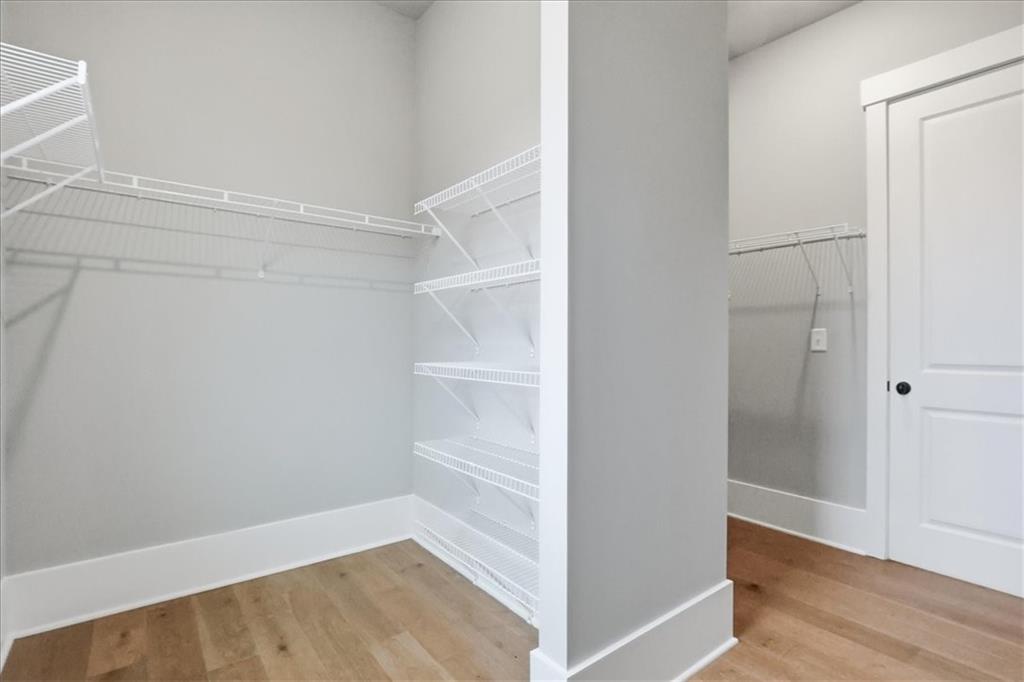170 Ewing Way Dacula, GA 30019 - Photo 43 of 67 a view of an empty walk in closet with wooden floor