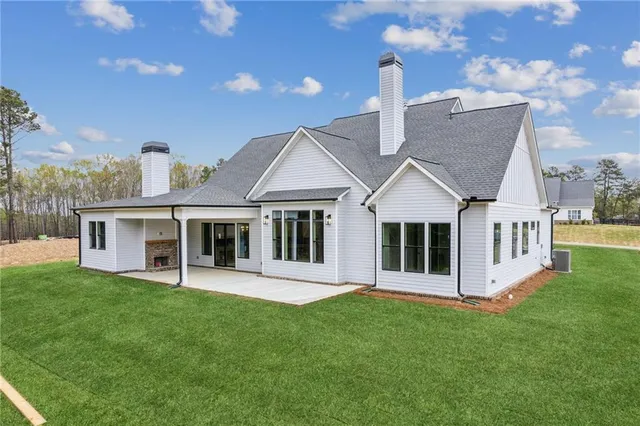 a front view of a house with a yard table and chairs