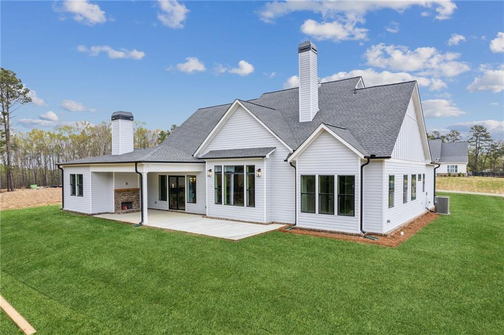 170 Ewing Way Dacula, GA 30019 - Photo 45 of 45 a front view of a house with a yard table and chairs