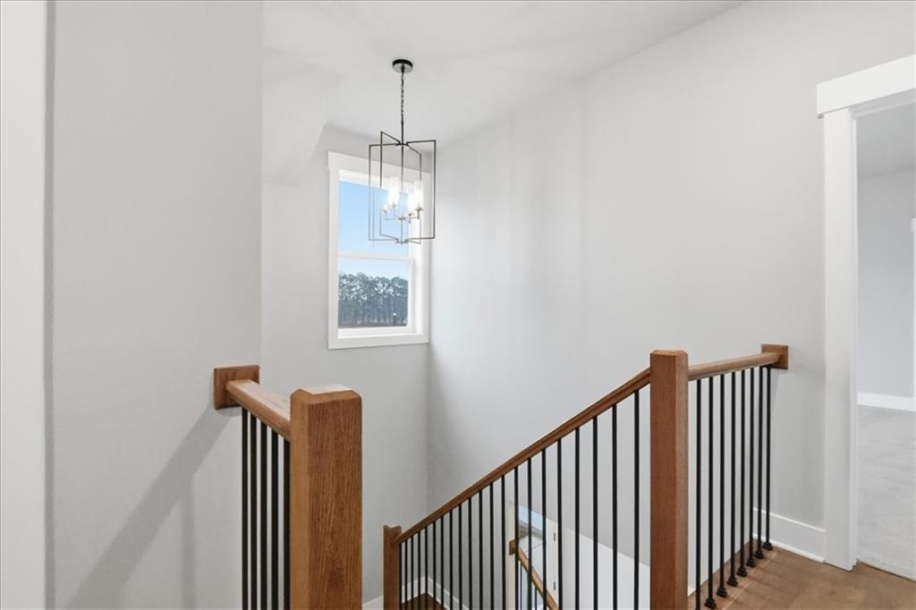 170 Ewing Way Dacula, GA 30019 - Photo 46 of 67 a view of a hallway with windows and chandelier