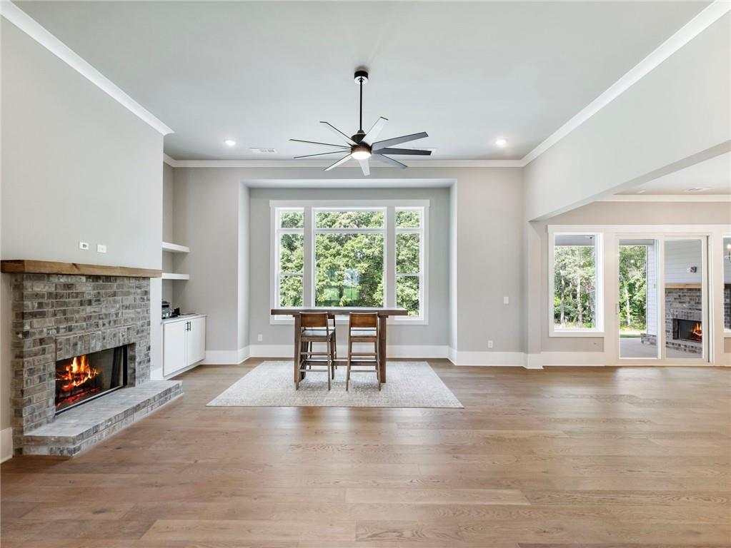 170 Ewing Way Dacula, GA 30019 - Photo 6 of 45 an empty room with fireplace wooden floor and windows