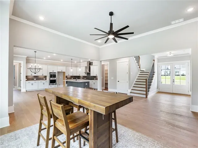 a dining room with furniture and wooden floor